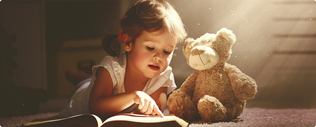 infant reading a book of kids