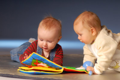 Babies playing with toys on floor